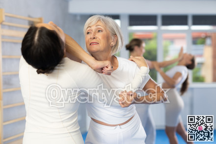 Young and elderly women training self-defense techniques