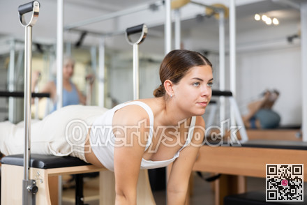 Young girl doing exercises on wunda chair in pilates studio