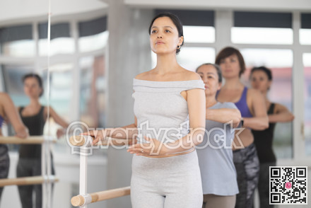 Female ballet enthusiast learning first position at group session