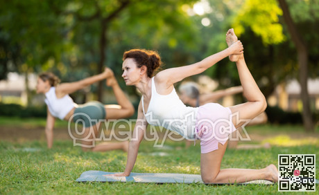 Adult woman doing yoga in park