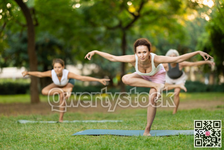 Mixed age group of women practicing yoga outside, doing relaxing stretching workout for body flexibility in park