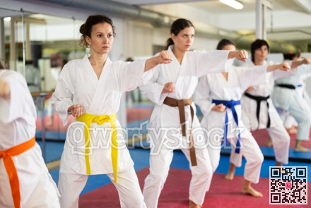 Group of women training karate techniques in studio