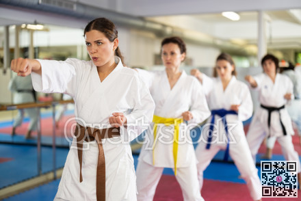 Group of womens practicing martial arts in gym. Active lifestyle and self defense concept