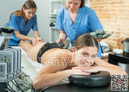 Portrait of a contented young woman receiving a massage procedure