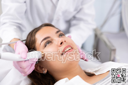 Young woman having face radiolifting procedure