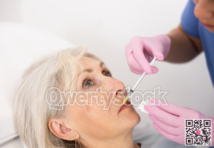 Old woman having mesotherapy procedure on her face