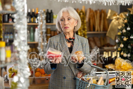 Elderly woman examines cheese in store on eve of New Year holidays