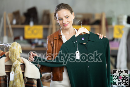 During November sales, woman choose and buy warm knitted dress