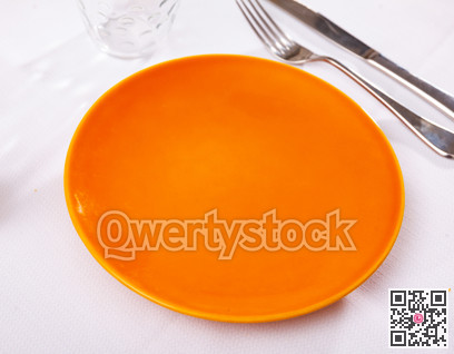 Empty plate and serving pieces on table