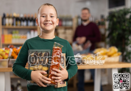 Child with sweets in the store