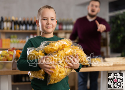 Boy chooses chips in grocery store