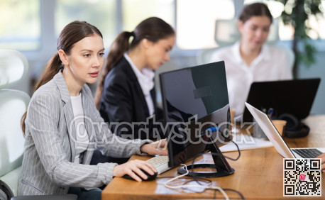 Young woman is a qualified specialist, works in a modern office