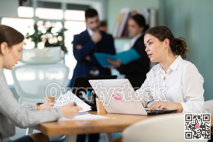Young woman is a qualified specialist, works in a modern office