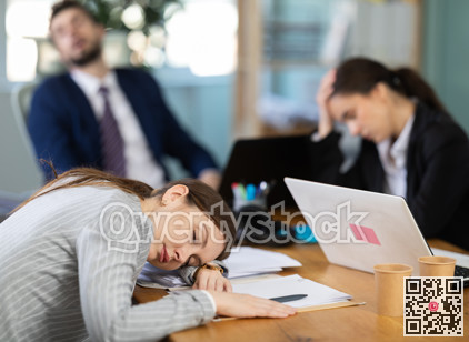 Young girl napping at desk after long stressful workday