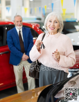 Elderly couple chooses new car together at car dealership