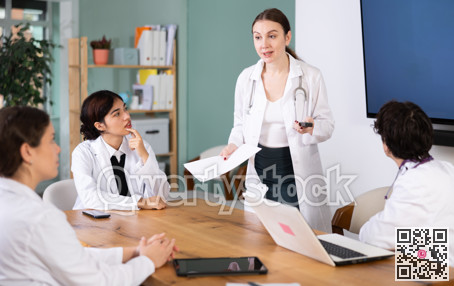 Young female doctor leading medical meeting in office