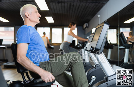 Elderly man, along with other people, is engaged on an bike in gym