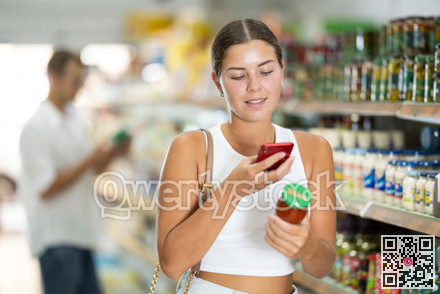 Girl buyer chooses red hot tomato sauce and scan QR code