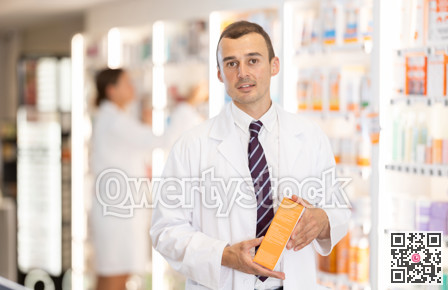 Young male pharmacist offering preparation in box