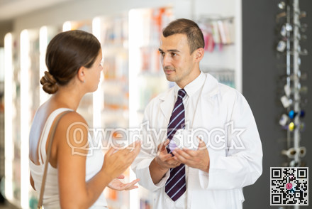 Male pharmacist consulting young girl about cosmetic cream