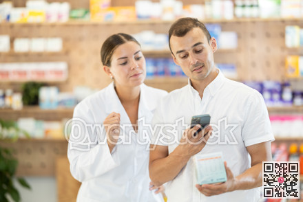 Young man customer scanning QR of medicine while female pharmacist consulting him