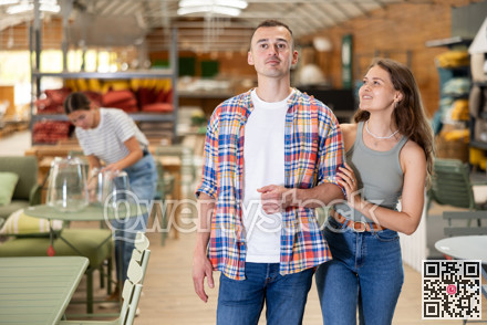 Cheerful couple browsing in home and garden furniture store