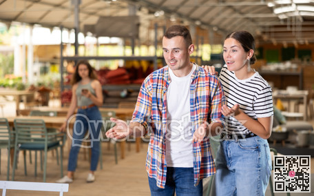 Friendly couple looking for comfortable furniture in garden store