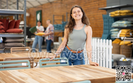 Interested young female shopper looking for outdoor table in store