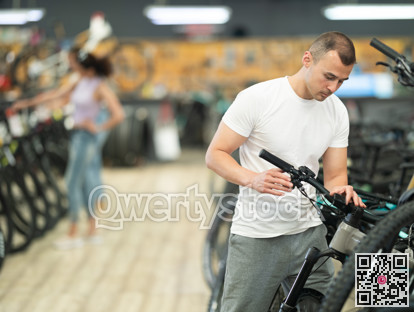 Young man choosing bike in store
