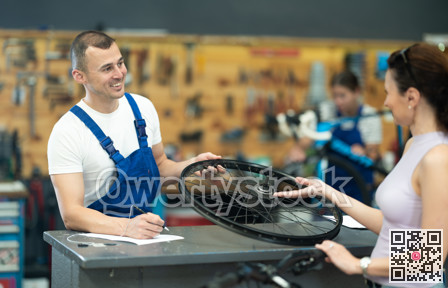 Bike mechanic discussing repair details with female customer