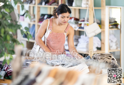 Latina chooses jeans in a clothing store