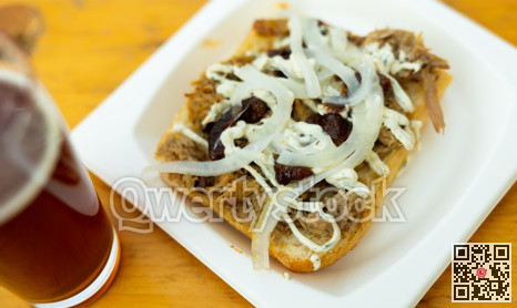 Sandwiches with lamb, sauce and onion served on white plate