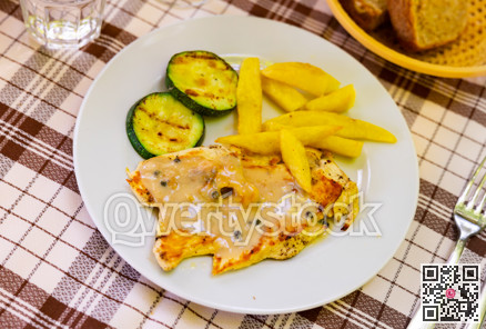 Tender meat of baked chicken breast with pepper garnished with French fries