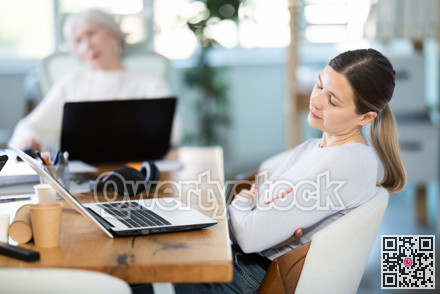 Tired businesswomens sleeping in the office with her head on table