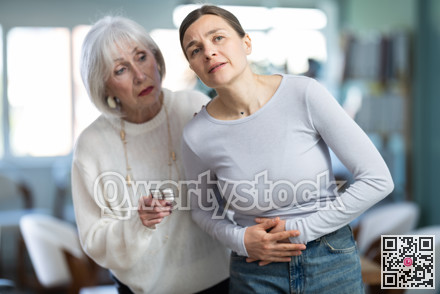 Adult woman with stomach pain, colleague gives painkillers