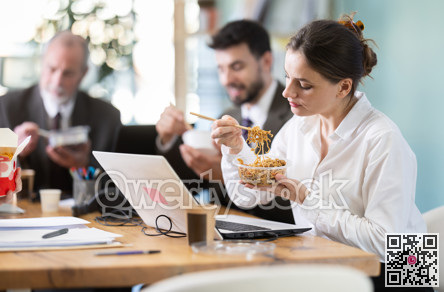 Young female companys employees eat instant noodles, lunch time during break for staff