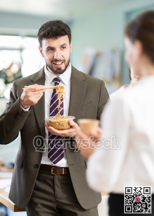 Male companys employees eat instant noodles, lunch time during break for staff