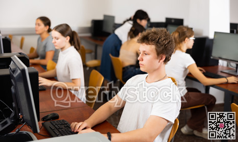 Clever focused male teenager solving tasks of computer science in the auditory