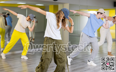 Teen girl in cap dancing modern dances