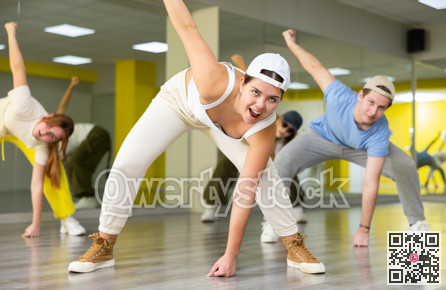 Young girl training breakdance drops in dance hall