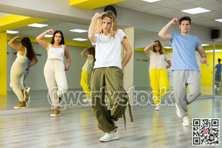 Teenage girl training breakdance Toprock moves in dance hall
