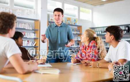 Group of schoolchildren in the school library, discussing something