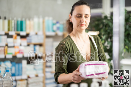 Woman are busy choosing feminine pads at pharmacy