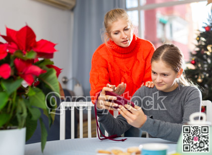 Girl sitting with phone and ignoring her mother