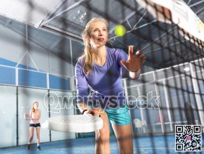 Caucasian woman with racquet playing padel