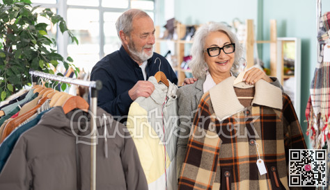 Elderly couple choosing jackets and coats together