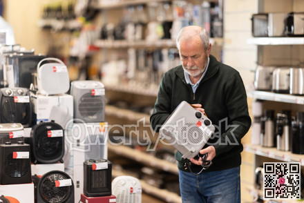 Eldery man chooses portable heater in appliance store