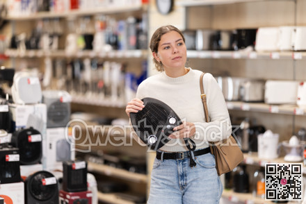 Young woman buying heater from hardware store