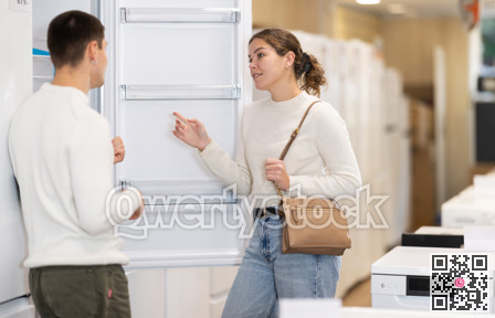 Couple choosing a refrigerator in an equipment store
