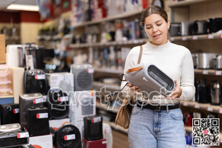 Girl customer inspect product range and selects fan heater